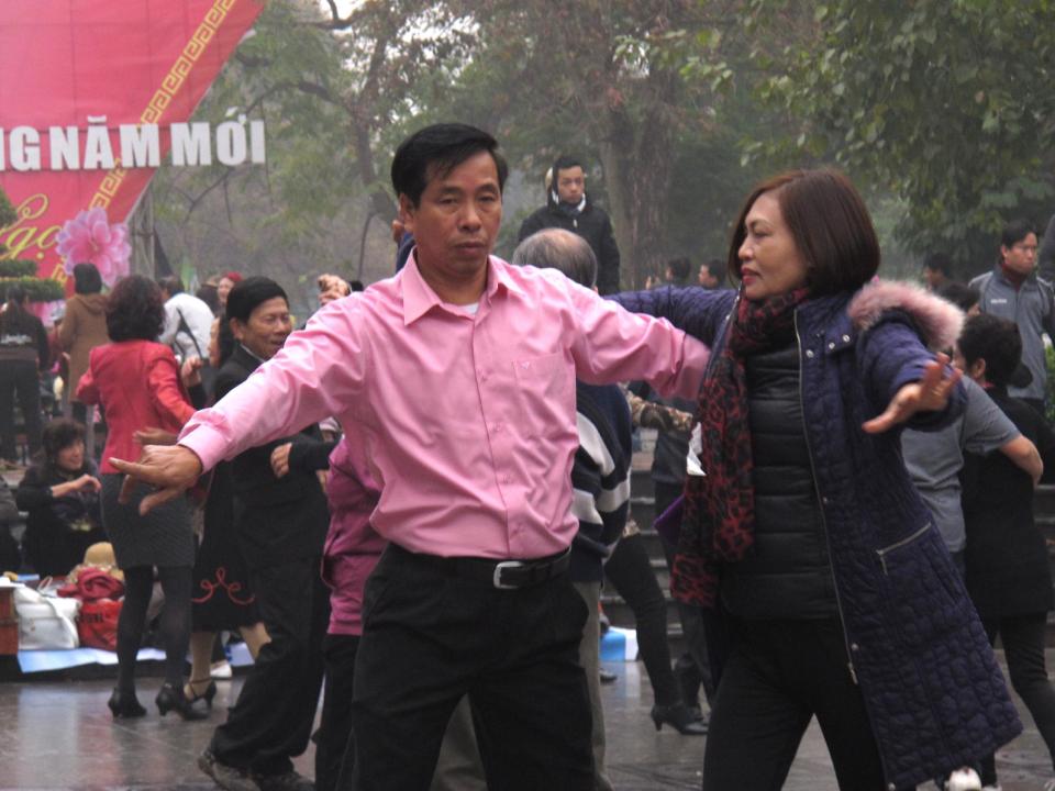 A Vietnamese couple ballroom dance close to a statue in the Vietnamese capital on Sunday, Feb. 16, 2014. Anti-China protestors hoping to lay wreathes at the statue said they believed the dancers were deployed by the government to stop them gathering there. The Vietnamese government is highly wary of public protests, and normally seeks to quash them. (AP Photos/Chris Brummitt)