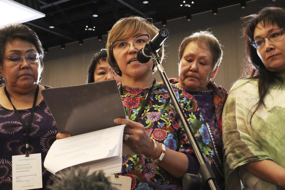 In this Oct. 20, 2018 photo, Elsie Boudreau, center, speaks at the Alaska Federation of Natives conference in Anchorage, Alaska. After going public with her story of abuse, Boudreau became an advocate for other survivors in Alaska Native communities through her nonprofit Arctic Winds Healing Winds organization. From left, are Alma Elia, Nancy Andrew (partly hidden), Boudreau, Florence Busch and Anna Sattler (Emily Swing/Reveal via AP)