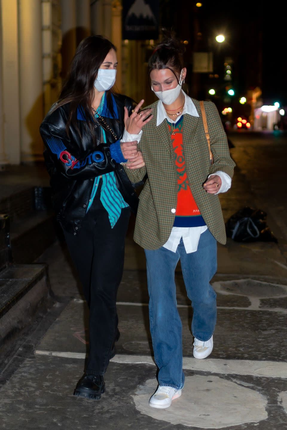 <p>The 23-year-old model was seen walking through the streets of Manhattan with a friend on Monday September 21 wearing a white face mask.</p><p>The star had spent the evening at The Ainsworth restaurant before taking a scooter ride home.</p><p>Hadid wore a laidback look for her night out which included oversized jeans, white trainers, a white shirt, orange jumper and gingham blazer. She teamed the look with a Louis Vuitton handbag.</p><p>The model is due to become an auntie any day now, with sister Gigi expected to give birth this month. </p>