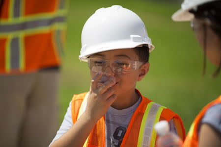 Jacob Rodriguez, 8, drinks recycled wastewater at the Edward C. Little Water Recycling Facility during the West Basin Municipal Water District's tour of a water recycling facility in El Segundo, California July 11, 2015. REUTERS/David McNew