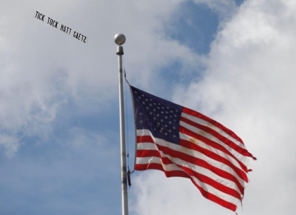 A plane trailing a banner that reads 'Tick Tock Matt Gaetz' flies over the Federal Courthouse in Orlando on Monday as former Seminole County tax collector Joel Greenberg pleaded guilty