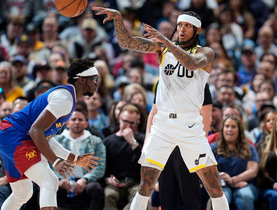 Utah Jazz guard Jordan Clarkson, right, passes the ball as Denver Nuggets guard Reggie Jackson defends during the first half of an NBA basketball game Saturday, March 9, 2024, in Denver.