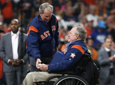 Oct 29, 2017; Houston, TX, USA; President George H.W. Bush hands the ball to President George W. Bush for the ceremonial first pitch in game five of the 2017 World Series between the Los Angeles Dodgers and the Houston Astros at Minute Maid Park. roy Taormina-USA TODAY Sports/Files