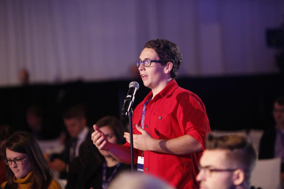 A student poses a question to the panel.