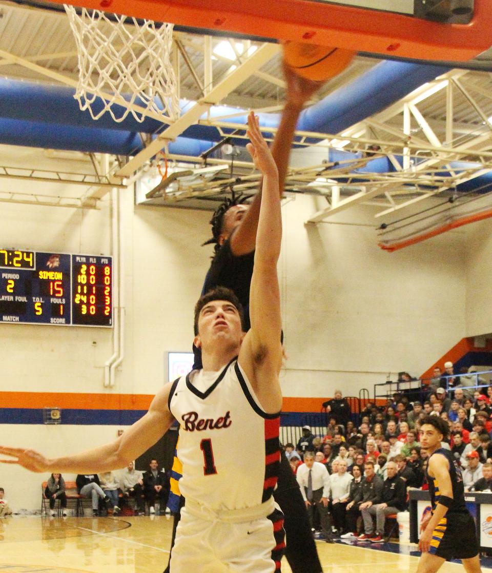 Simeon's Miles Rubin blocks a Benet's Sam Driscoll shot attempt off the backboard during Friday's Pontiac Holiday Tournament championship game. Simeon rejected Benet 52-49 for its 16th all-time PHT title.