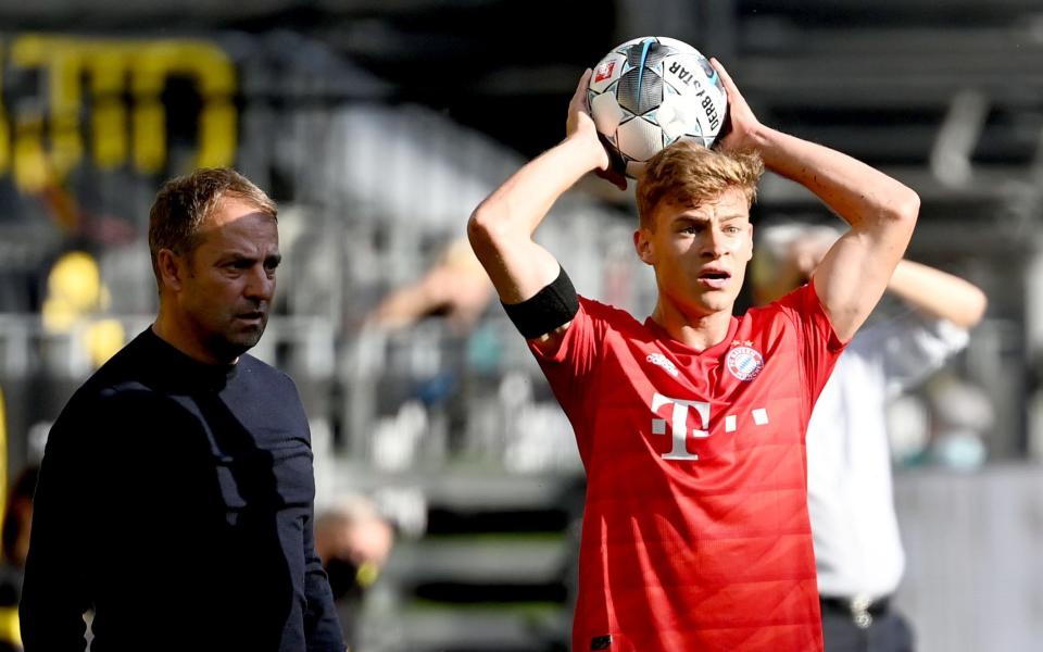 Joshua Kimmich (R) of Bayern Munich in action next to Bayern Munich's head coach Hansi Flick  - Shutterstock