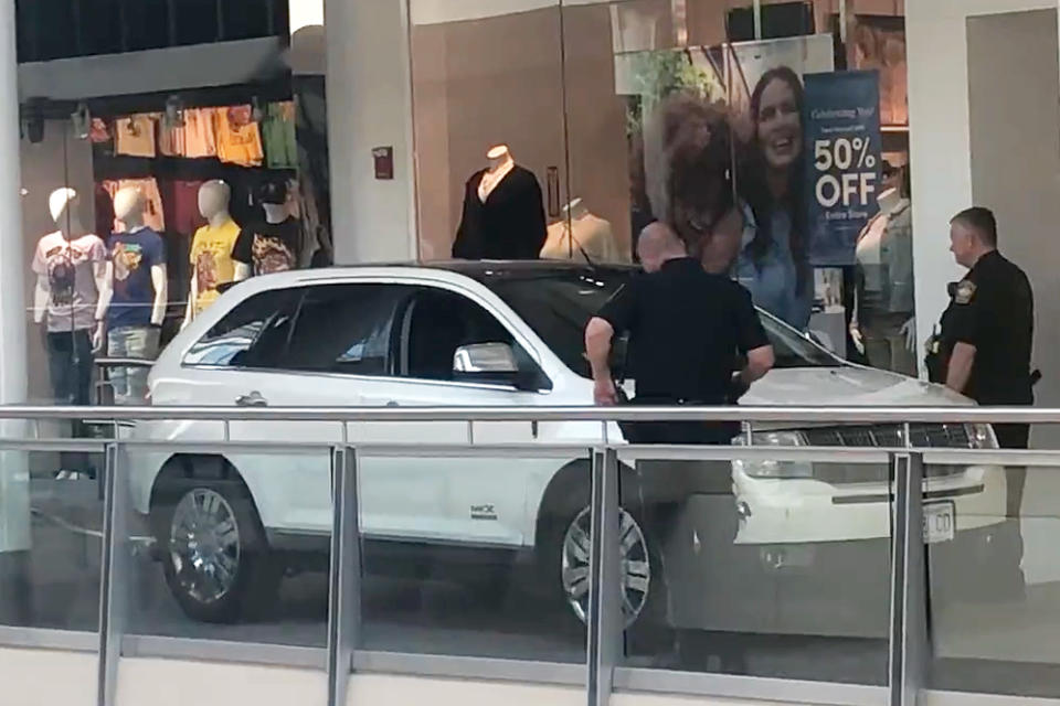 Police investigate a SUV vehicle accident inside South Shore Plaza mall in Braintree, Mass., on Aug. 18, 2022. (@ghettova via Twitter)