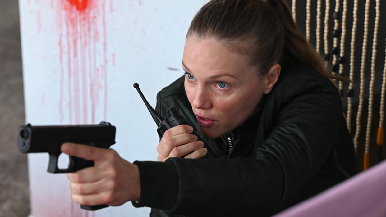  Tracy Spiridakos fends off gunfire as Upton on Chicago P.D. Season 11 finale. 