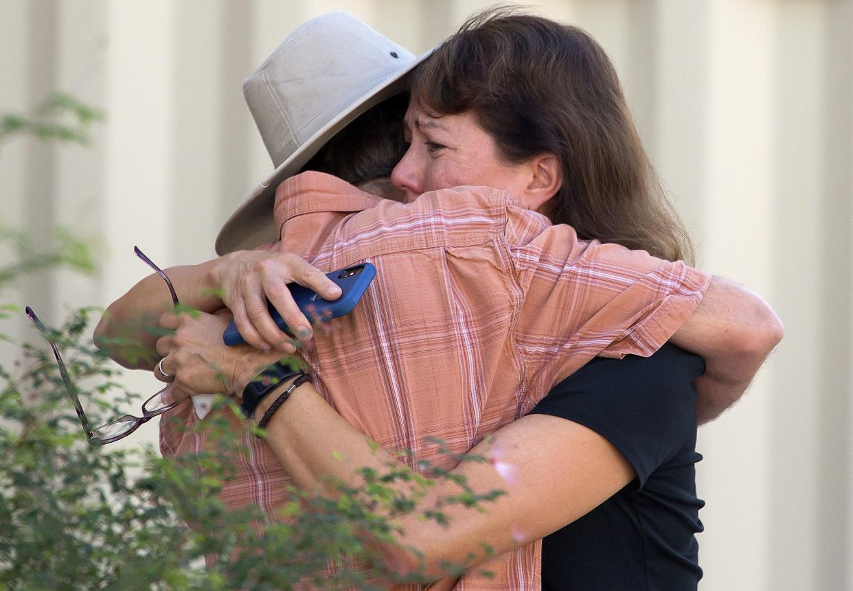 Two people hug after a shooting at the John W. Harshbarger Building on the University of Arizona campus in Tucson, Ariz., on Wednesday, Oct. 5, 2022.