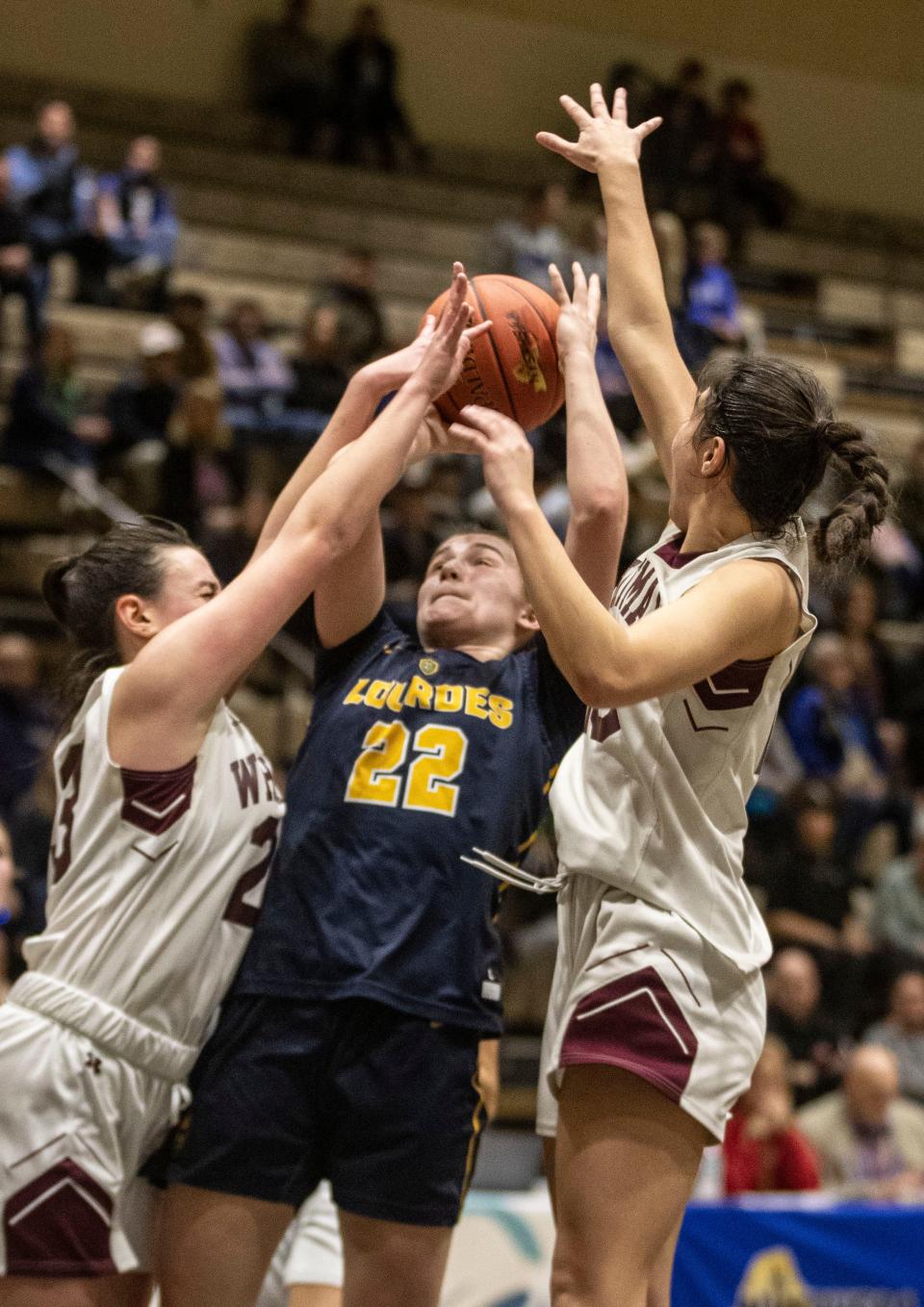 Simone Pelish of Our Lady of Lourdes is fouled by Brianna Verga of Walt Whitman during a New York State girls Class AAA basketball semifinal against at Hudson Valley Community College in Troy March 16, 2024. Lourdes defeated Walt Whitman 60-51 to advance to the Class AAA final on Sunday.