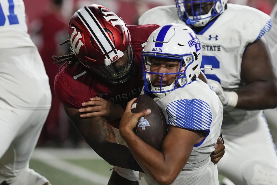 Indiana State quarterback Evan Olaes, center right, is sacked by Indiana defensive lineman Andre Carter (1) during the second half of an NCAA college football game, Friday, Sept. 8, 2023, in Bloomington, Ind. (AP Photo/Darron Cummings)