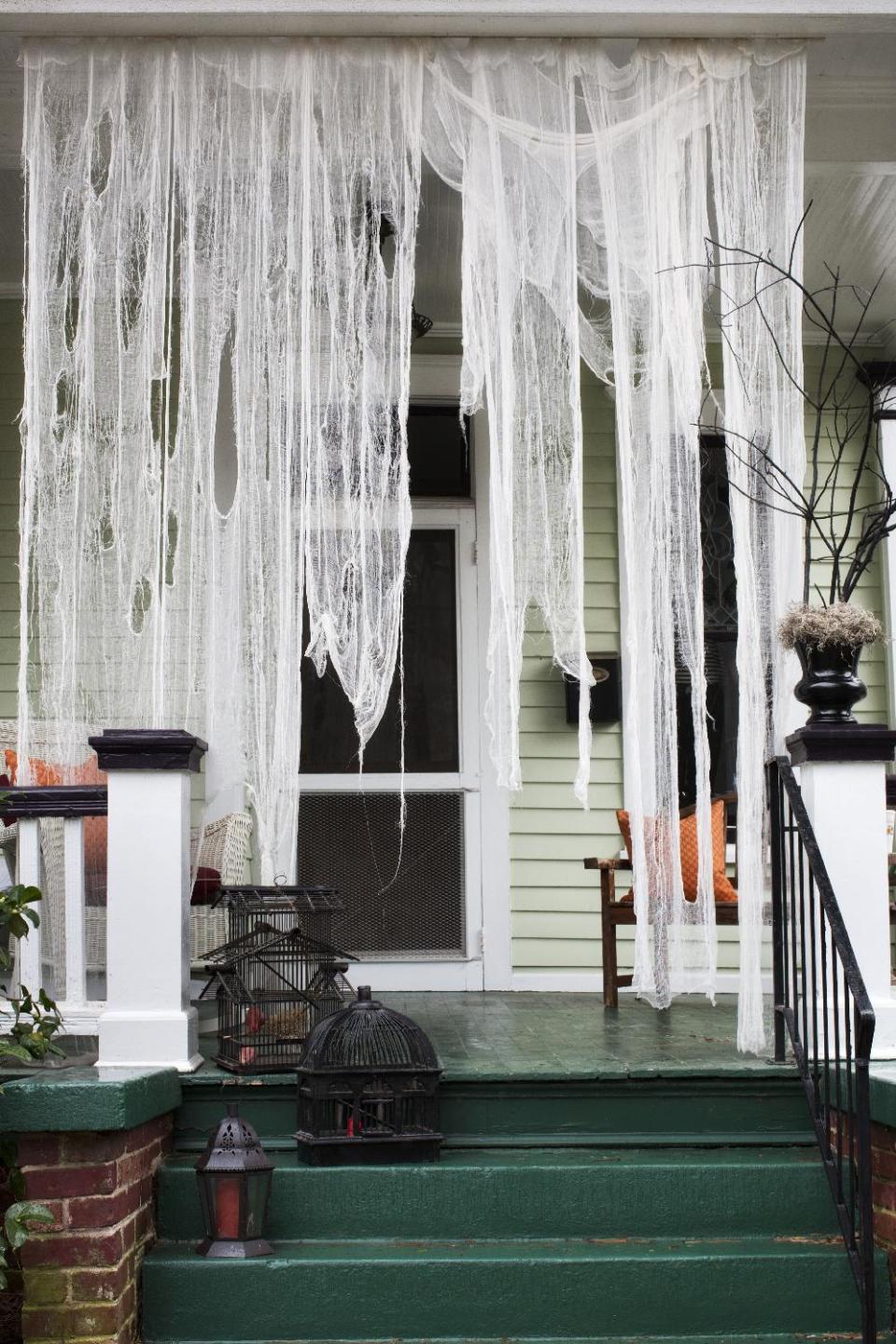 This undated photo provided by Brian Patrick Flynn shows a haunted-house entryway, with ripped pieces of cheesecloth that were soaked in weak tea, created by designer, Brian Patrick Flynn for HGTV.com, in Atlanta. Once dried, pieces can be draped from staples or small nails. Start the party before your guests even enter your home. (AP Photo/Brian Patrick Flynn/HGTV.com, Scripps Networks Interactive/Sarah Dorio)