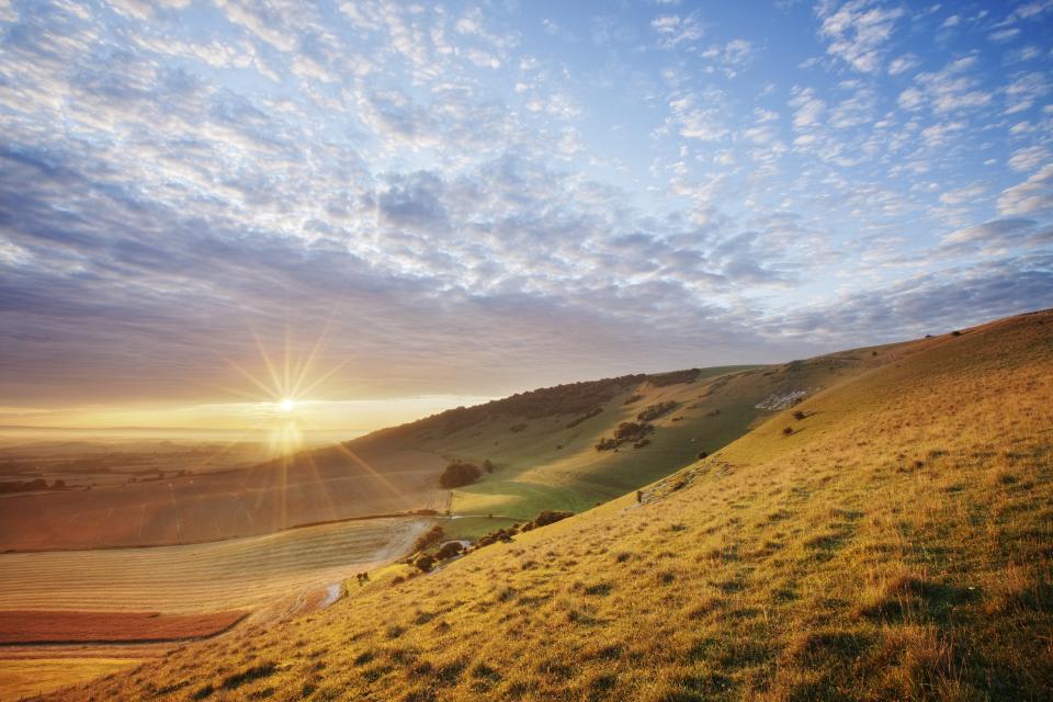 Sunrise over chalk downland viewed from Wilmington Hill, Wilmington, South Downs National Park, East Sussex