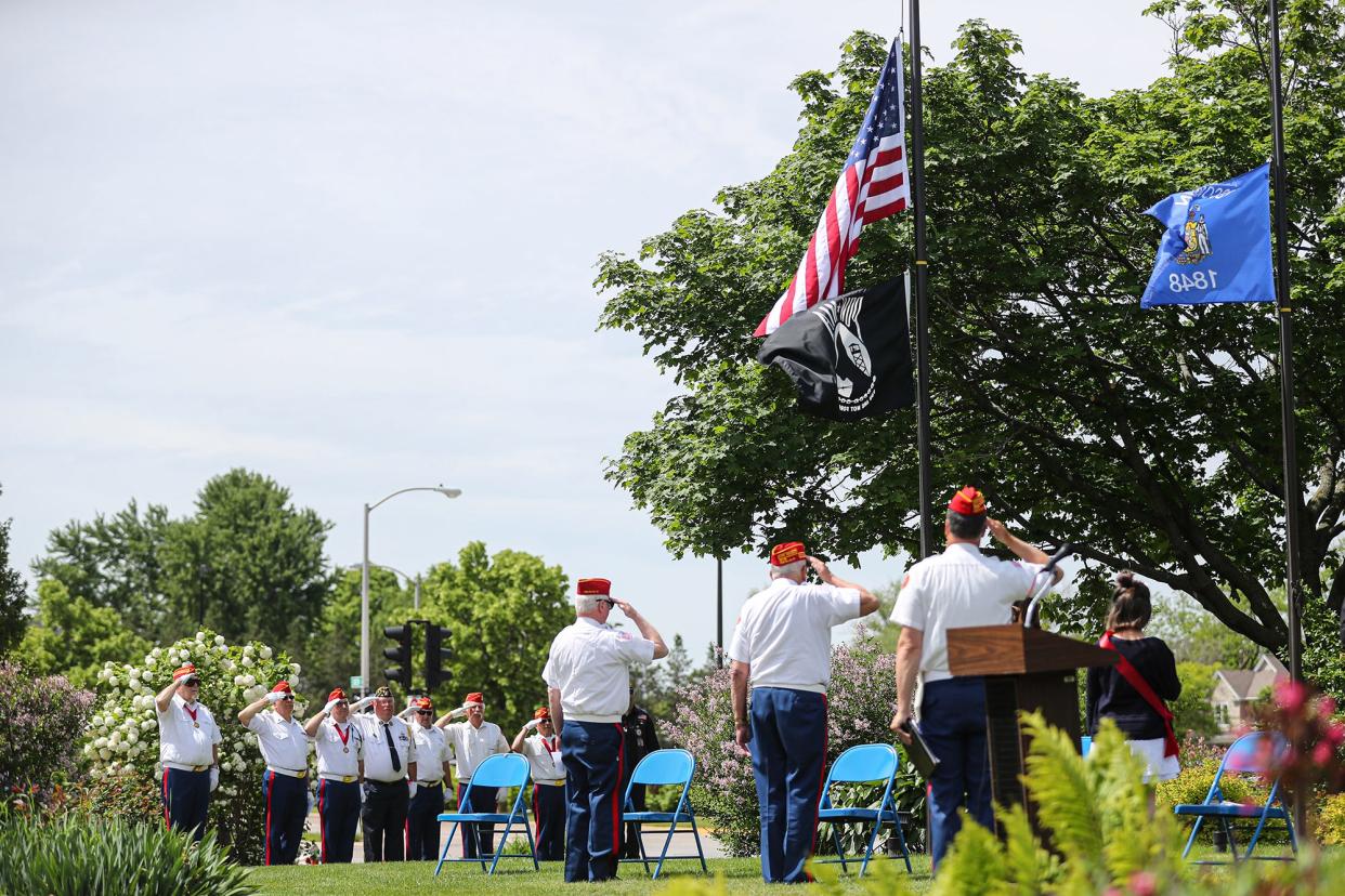 Military veterans salute the American flag May 31, 2021, during the national anthem at a Memorial Day ceremony in Veterans Park in Fond du Lac.