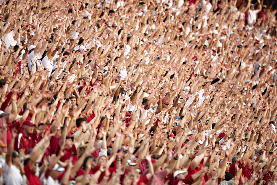 FAYETTEVILLE, ARKANSAS – SEPTEMBER 11: Fans of the Arkansas Razorbacks Call The Hogs in the first half of a game against the <a class="link " href="https://sports.yahoo.com/ncaaf/teams/texas/" data-i13n="sec:content-canvas;subsec:anchor_text;elm:context_link" data-ylk="slk:Texas Longhorns;sec:content-canvas;subsec:anchor_text;elm:context_link;itc:0">Texas Longhorns</a> at Donald W. Reynolds Razorback Stadium on September 11, 2021 in Fayetteville, Arkansas. (Photo by Wesley Hitt/Getty Images)