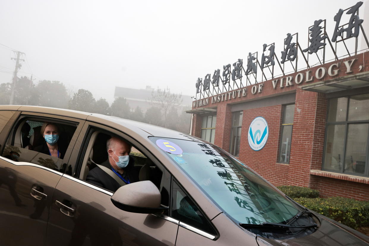 Peter Daszak and Thea Fischer, members of the WHO team tasked with investigating the origins of COVID-19, sit in a car arriving at Wuhan Institute of Virology in Wuhan, China, on Feb. 3, 2021. 