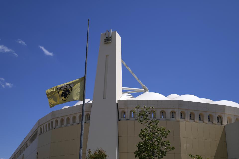 An AEK Athens team flag is at half staff outside OPAP Arena, after overnight clashes between rival supporters in Nea Philadelphia suburb, in Athens, Greece, Tuesday, Aug. 8, 2023. European governing soccer body UEFA says it has postponed a Champions League qualifying game between AEK Athens and Croatia's Dinamo Zagreb scheduled for Tuesday because of the violence. Eight fans were injured while Greek police said Tuesday they had made 88 arrests, mostly of Croatian supporters. (AP Photo/Thanassis Stavrakis)