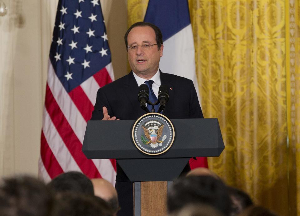 French President François Hollande gestures during a joint news conference with President Barack Obama, as part of an official state visit, Tuesday, Feb. 11, 2014, in the East Room of the White House in Washington. Lauding the "enduring alliance" between the United States and France, President Barack Obama on Tuesday welcomed President Francois Hollande to the White House for a lavish state visit. The highly anticipated trip is taking place amid swirling speculation on both sides of the Atlantic about problems in Hollande's personal life. (AP Photo/ J. Scott Applewhite)