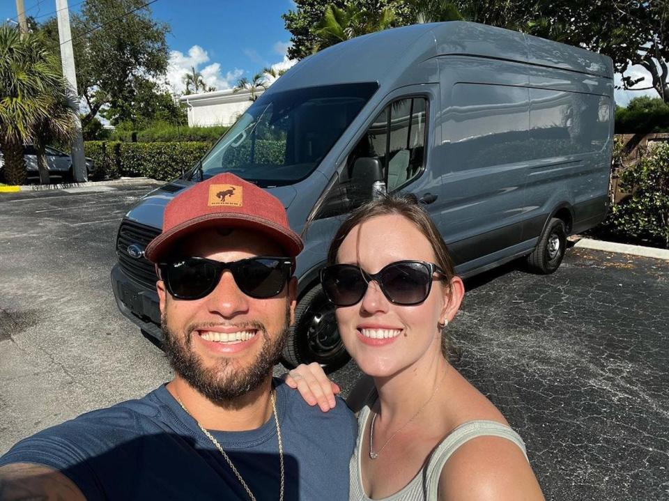 Hope and Manny Hernandez stand in front of their renovated tiny home on wheels.