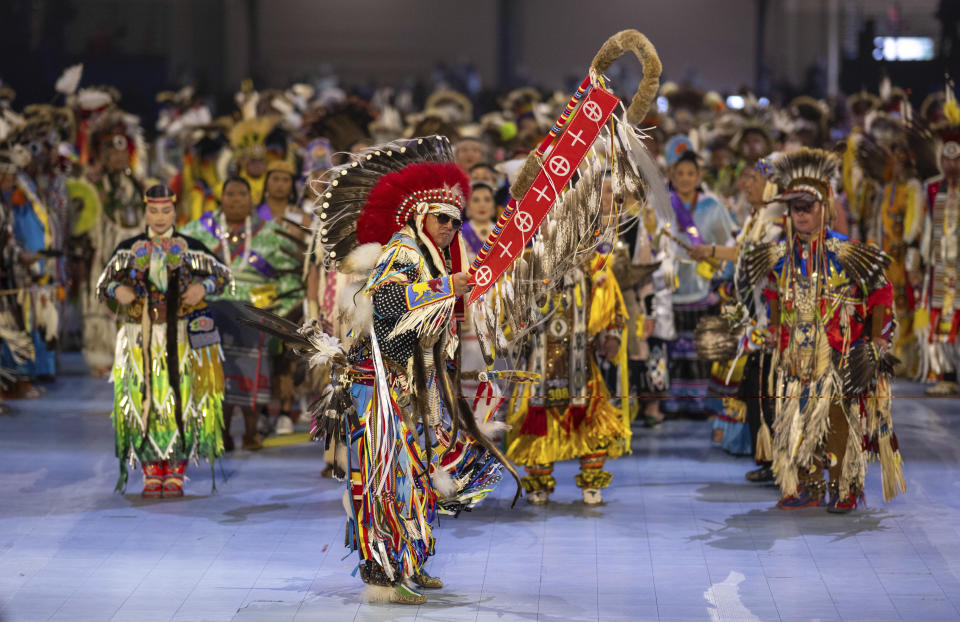 Head Man Dancer Julius Not Afraid of Rocky Boy, Montana leads over a thousand dancers in the arena for the grand entry at the 40th anniversary of the Gathering of Nations Pow Wow in Albuquerque, N.M., Friday, April 28, 2023. The annual Gathering of Nations kicked off Friday with a colorful procession of Native American and Indigenous dancers from around the world moving to the beat of traditional drums as they fill an arena at the New Mexico state fairgrounds. (AP Photo/Roberto E. Rosales)