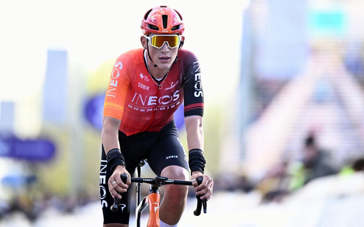 British Josh Tarling of Ineos Grenadiers crosses the finish line of the men elite race of the 'Dwars Door Vlaanderen' cycling race, 188,6 km from Roeselare to Waregem