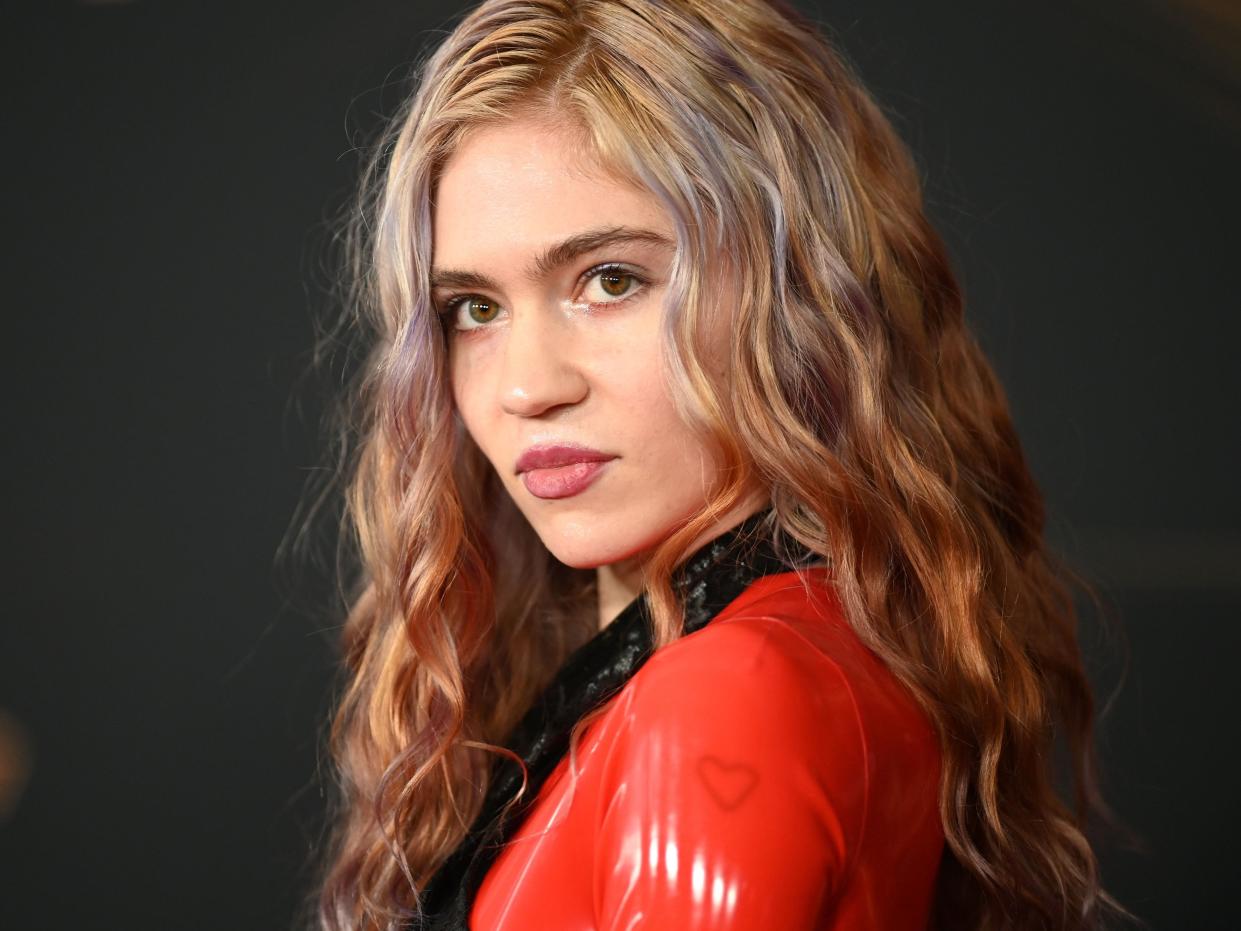 Photo of Grimes wearing a red costume