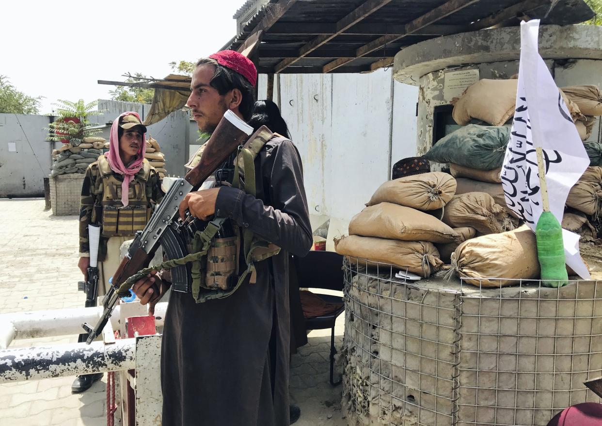 Taliban fighters stand guard at a checkpoint near the US embassy that was previously manned by American troops, in Kabul, Afghanistan, Tuesday, Aug. 17, 2021.