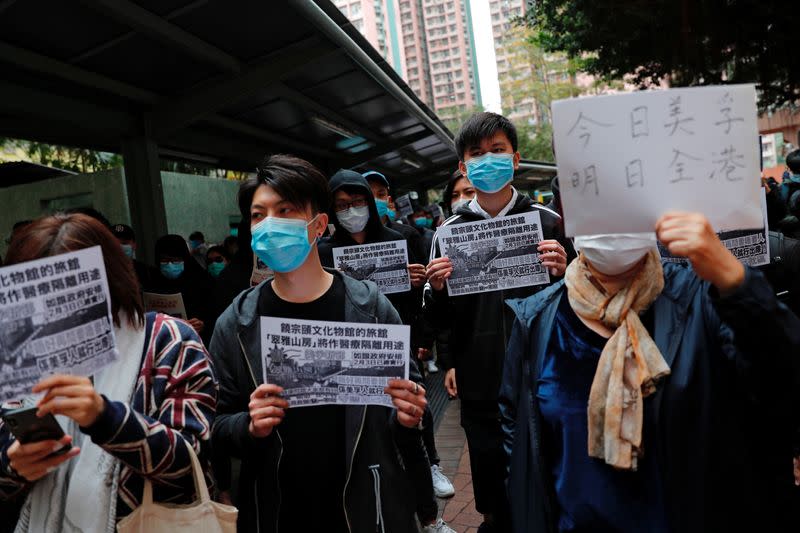 Residents wear facial masks as they march to protest against the government's plan to set up a quarantine site close to their community amid the Wuhan outbreak, in Hong Kong