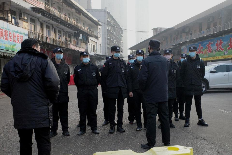 Security guards stand in front of the closed Huanan wholesale seafood market where a man with coronavirus died (AFP via Getty Images)