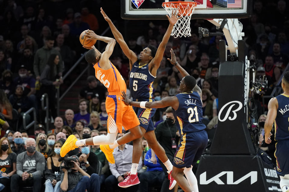 Phoenix Suns forward Mikal Bridges (25) shoots over New Orleans Pelicans forward Herbert Jones (5) during the first half of an NBA basketball game, Friday, Feb. 25, 2022, in Phoenix. (AP Photo/Matt York)