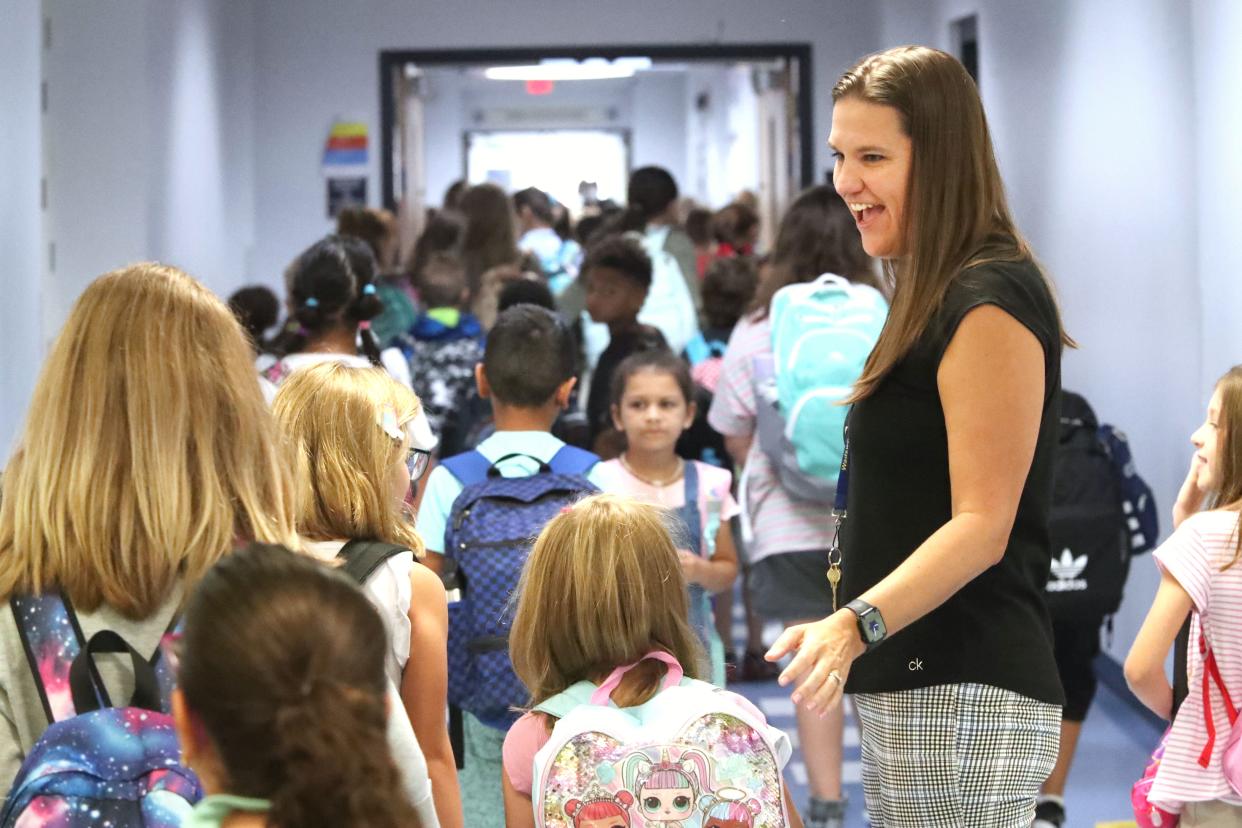 Wadsworth Elementary School teacher Lesley Poland greets students heading to classes, Wednesday, Aug. 10, 2022, as Flagler County students return on the first day of school.