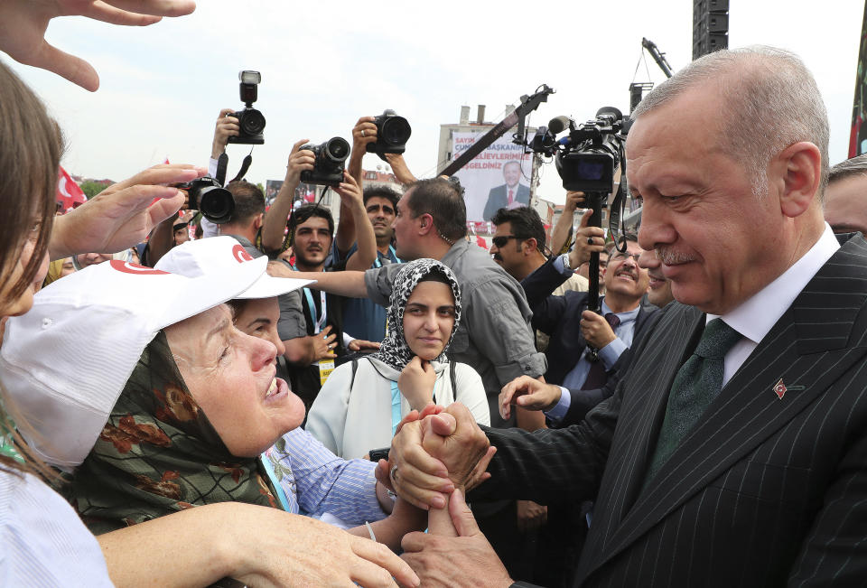 In this Thursday, June 20, 2019 photo, Turkey's President Recep Tayyip Erdogan, talks to a supporter during an election rally in Istanbul. Millions of voters in Istanbul go back to the polls for a controversial mayoral election re-run Sunday, as President Recep Tayyip Erdogan's party tries to wrest back control of Turkey's largest city. (Presidential Press Service via AP, Pool)