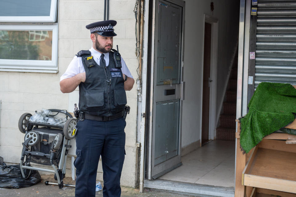 Police outside the family's Ilford home. (SWNS)