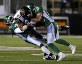 Hamilton Tiger-Cats Andy Fantuz (83) is tackled by Saskatchewan Roughriders Dwight Anderson (33) and Craig Butler (28) during the second half of the CFL's 101st Grey Cup championship football game in Regina, Saskatchewan November 24, 2013. REUTERS/Todd Korol (CANADA - Tags: SPORT FOOTBALL)
