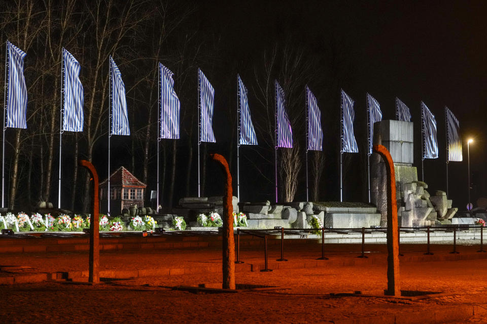 Flowers are placed by the memorial monument at the Birkenau Nazi death camp in Oswiecim, Poland, Saturday, Jan. 27, 2024. Survivors of Nazi death camps marked the 79th anniversary of the liberation of the Auschwitz-Birkenau camp during World War II in a modest ceremony in southern Poland.(AP Photo/Czarek Sokolowski)