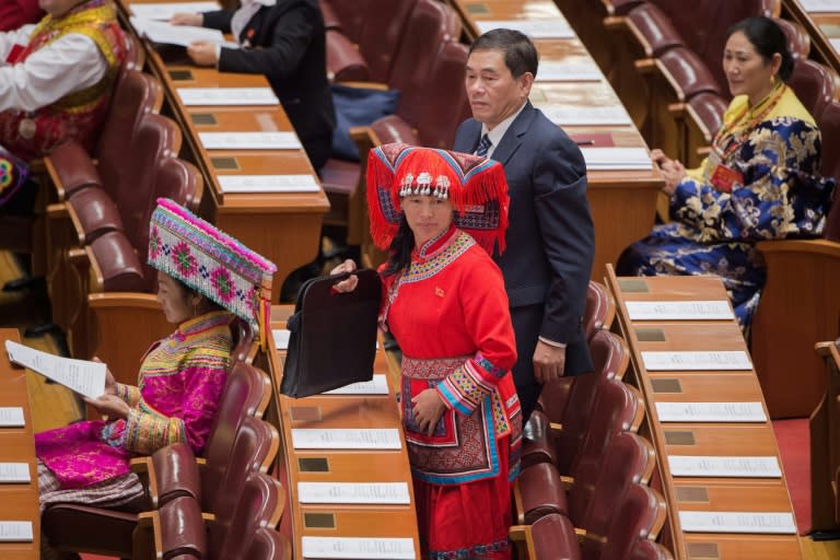 Delegates, some wearing ethnic minority outfits, arrive at the opening of the 19th Communist Party Congress at the Great Hall of the People in Beijing on October 18, 2017