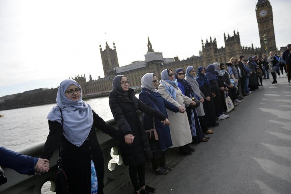 Tribute: Members of the 'Women's March' rally on Westminster Bridge (EPA)