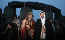 Crowds gather at dawn amongst the stones at Stonehenge in Wiltshire for the Summer Solstice.