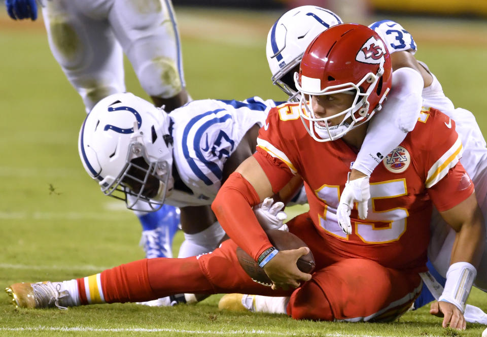 Indianapolis Colts defensive end Kemoko Turay (57) and Indianapolis Colts safety Khari Willis (37) wrap-up Kansas City Chiefs quarterback Patrick Mahomes (15) after Mahomes scrambled for a first down in the fourth quarter on Sunday, Oct. 6, 2019 at Arrowhead Stadium in Kansas City, Mo. (Rich Sugg/Kansas City Star/Tribune News Service via Getty Images)