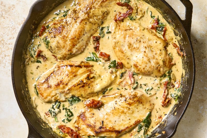 overhead shot of tuscan chicken in a cast iron skillet.