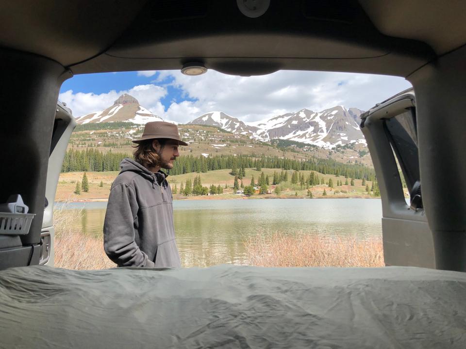 Iver pictured out the back of the van, at a campground in Colorado's San Juan National Forest.