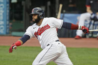Cleveland Indians' Carlos Santana watches his RBI single during the first inning of the team's baseball game against the Minnesota Twins, Tuesday, Aug. 25, 2020, in Cleveland. (AP Photo/Tony Dejak)