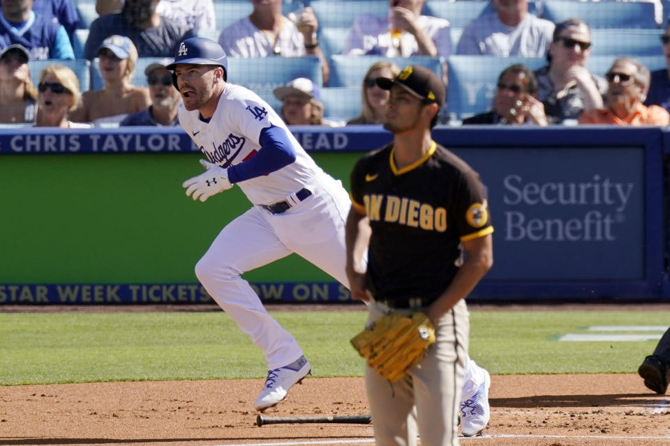 Los Angeles Dodgers' Freddie Freeman, left, heads to first after hitting a solo home run as San Diego Padres starting pitcher Yu Darvish watches during the first inning of a baseball game Saturday, July 2, 2022, in Los Angeles. (AP Photo/Mark J. Terrill)