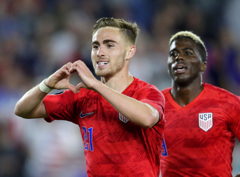 United States' Tyler Boyd, left, celebrates his goal against Guyana with fans as teammate Gyasi Zardes follows during the second half of a CONCACAF Gold Cup soccer match Tuesday, June 18, 2019, in St. Paul, Minn. (AP Photo/Andy Clayton-King)
