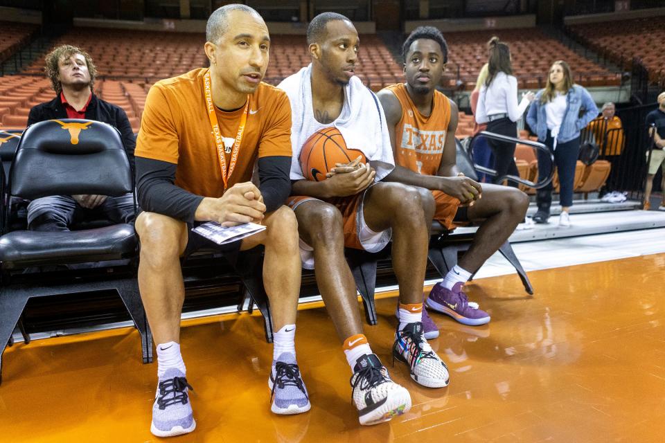 Texas coach Shaka Smart, left, joins guards Matt Coleman III, center, and Courtney Ramey before a 2019 practice. One of the most popular coaches on campus during his time at Texas, Smart couldn't coax an NCAA win from his team during his six years on campus.