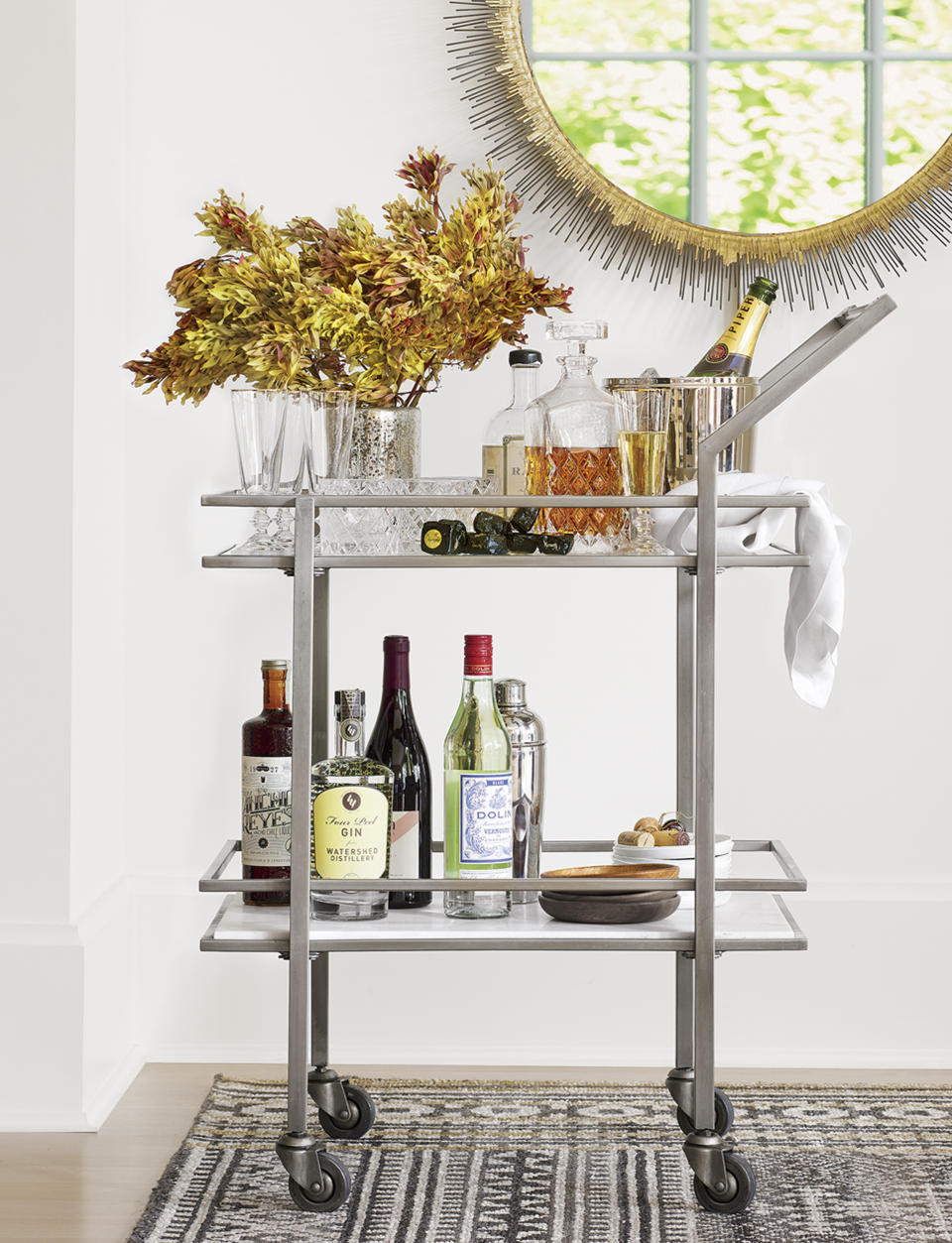 This photo provided by Crate & Barrel shows a bar cart. An item like this can lend a hand in entertaining in a small space. With a little planning, even the smallest homes can be just right for holiday entertaining. (Crate & Barrel via AP)