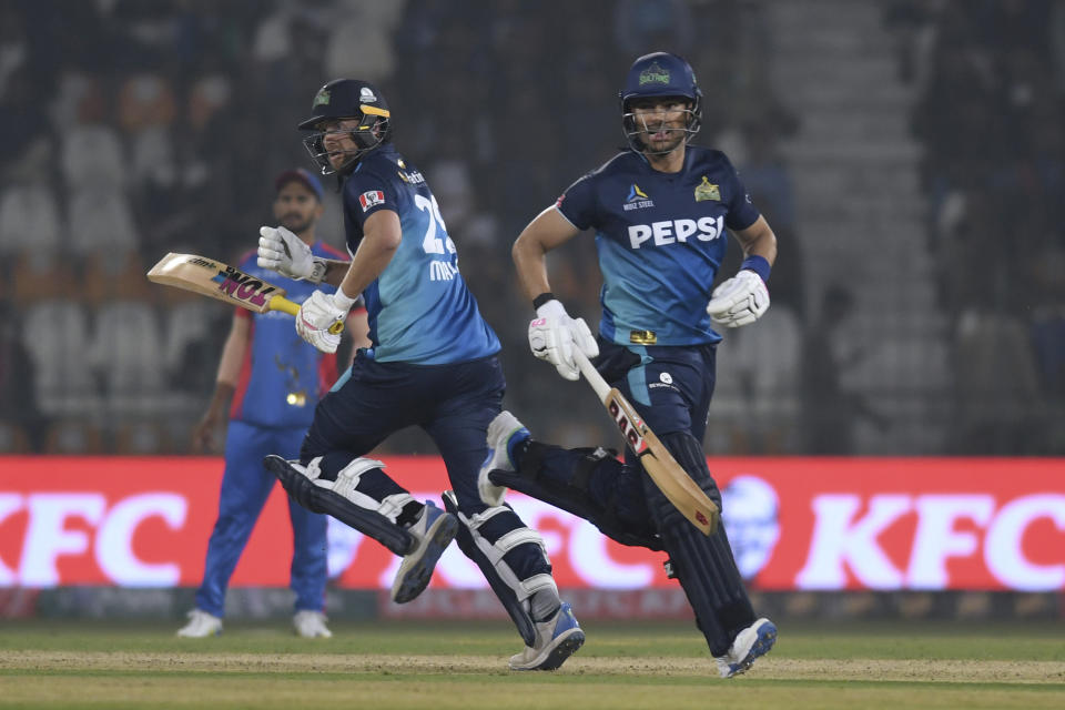 Multan Sultans' Dawid Malan, right, and Reeza Hendricks run between the wickets during the Pakistan Super League T20 cricket match between Multan Sultans and Karachi Kings in Multan, Pakistan Sunday, Feb. 18, 2024. (AP Photo/M. Khan)