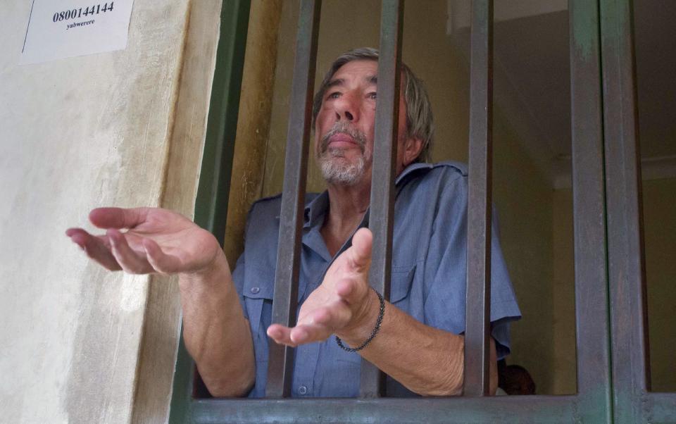 Briton Bernard Randall, 65, stands in a holding cell after a court hearing which ordered him to be deported, at the Chief Magistrates court in Entebbe, Uganda Wednesday, Jan. 22, 2014. A Ugandan court on Wednesday ordered the deportation of Randall who faced criminal charges following publication of images of him having sex with another man, in Uganda where homosexuality is illegal and lawmakers recently passed a draconian new bill that prescribes life imprisonment for "aggravated" homosexual acts. (AP Photo/Rebecca Vassie)