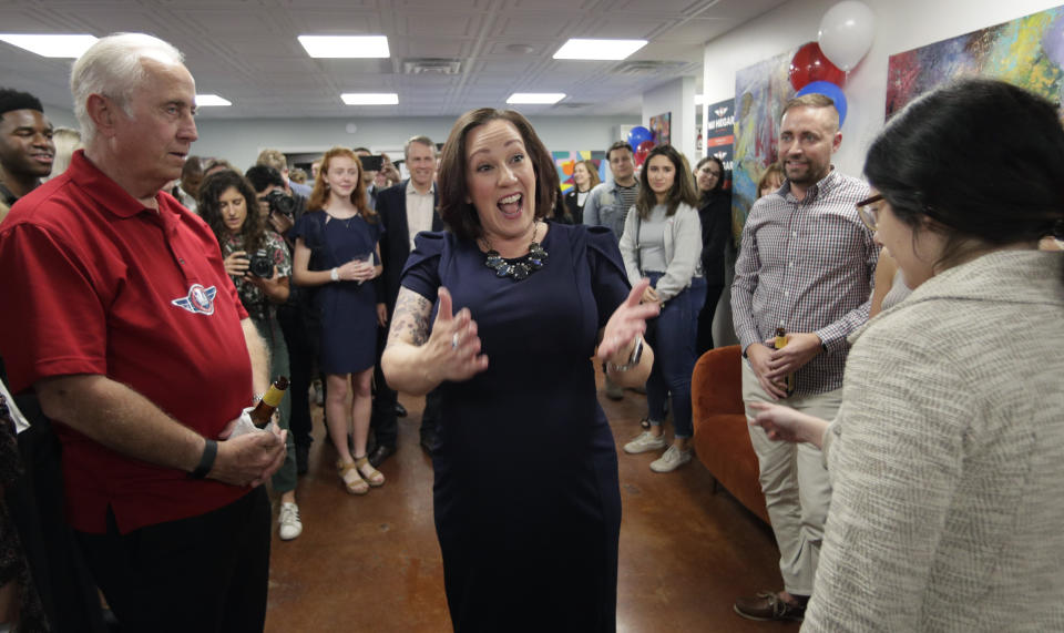 Democratic U.S. Senate candidate MJ Hegar, center, greets supporters during her election night party in Austin, Texas, Tuesday, March 3, 2020. (AP Photo/Eric Gay)