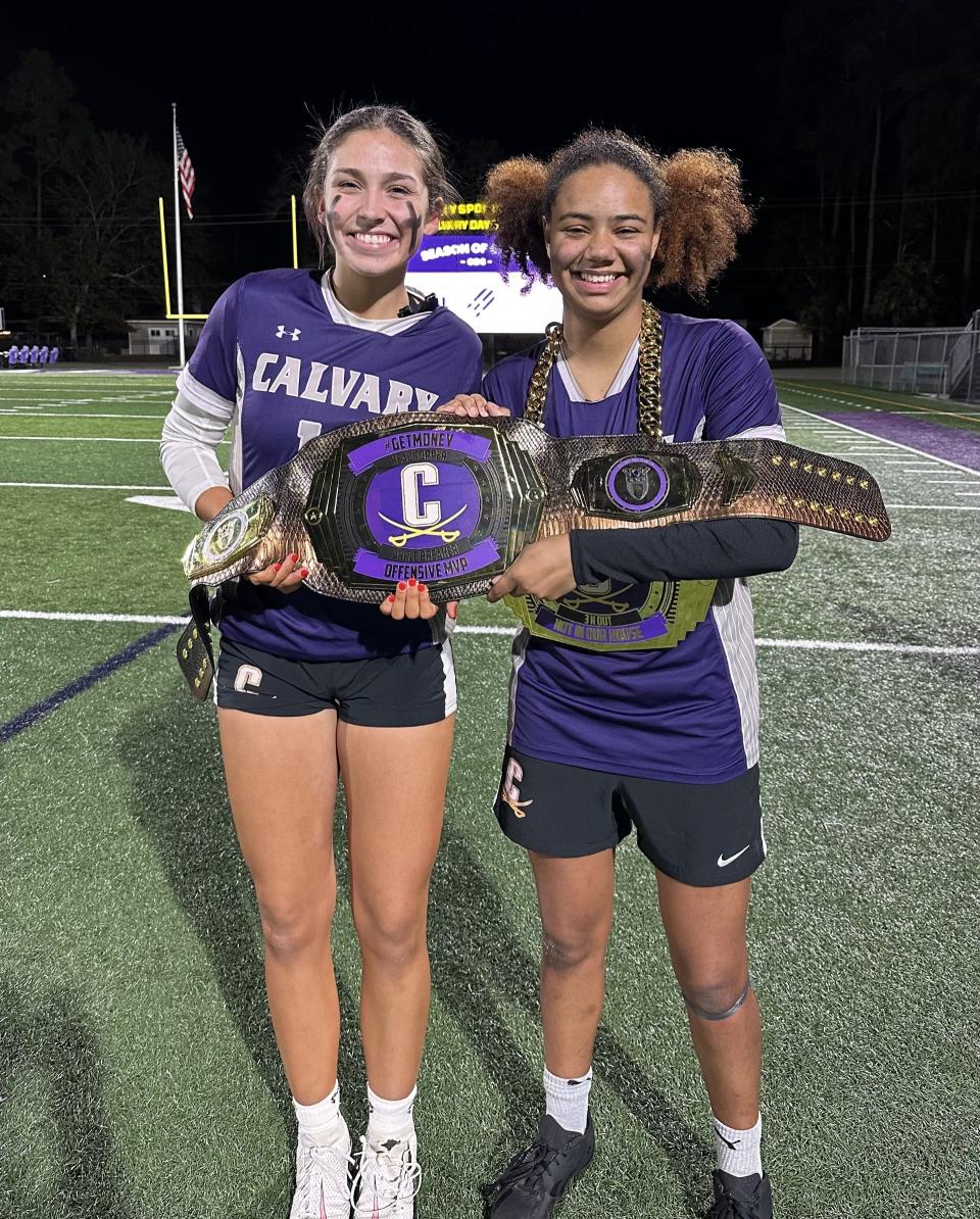 Sierra Lowery (right) and McKenzie Clayton of the Calvary Day flag football team after a playoff win over Dodge County Tuesday.